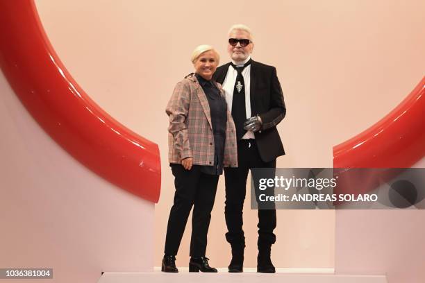 Fashion designers Karl Lagerfeld and Silvia Venturini Fendi acknowledge applause following the presentation of the Fendi fashion collection during...