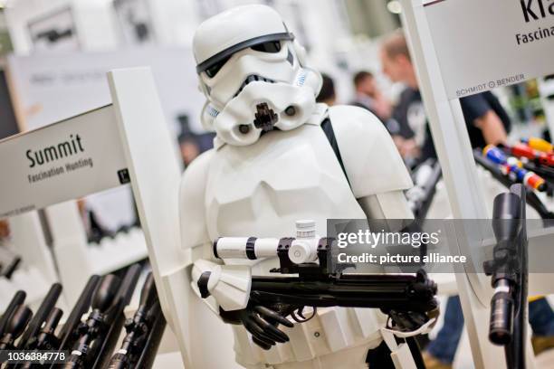 Life-sized doll depicting a storm trooper of the 'Star Wars' films holds a telescopic sight of 'Schmidt und Bender' in its hands at the hunting and...