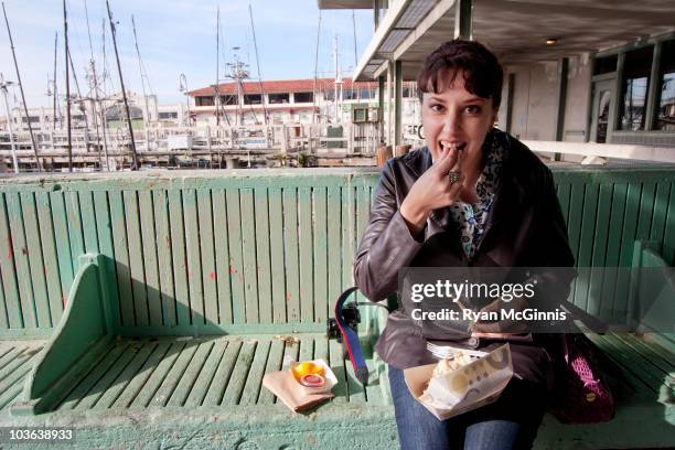 woman eating crab - fishermans wharf stock pictures, royalty-free photos & images