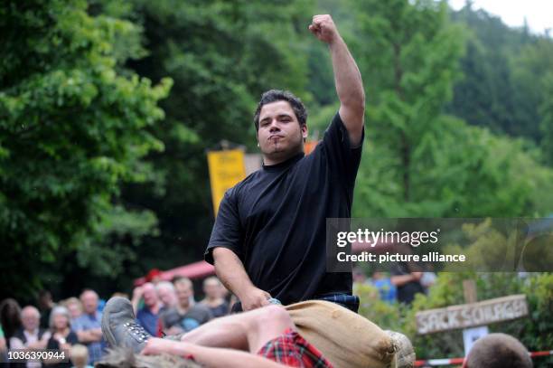 Man celebrates after his victoryin an event as part of the first Highland Games in Ennepetal, Germany, 20 July 2013. The Highland Games are a...