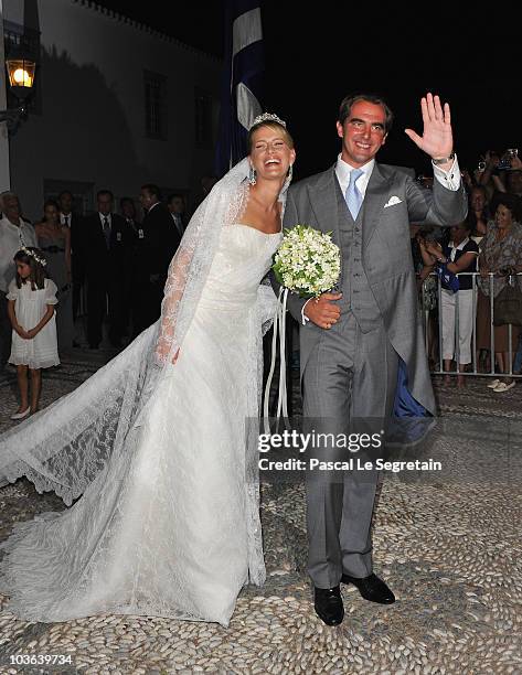 Tatania Blatnik and Prince Nikolaos of Greece walk outside the Cathedral of Ayios Nikolaos after their wedding ceremony on August 25, 2010 in...