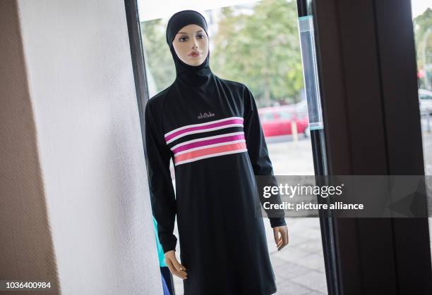 Mannequin wearing a burkini stands in the shop window of a careshop in Berlin, Germany, 18 August 2016. Be it the ban of burkinis in France or the...