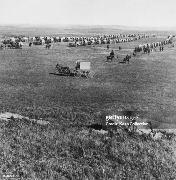 Covered wagons and riders on horseback gather during Custer's Black Hills Expedition, USA, circa 1874. The expedition, led by then-Lieutenant Colonel...