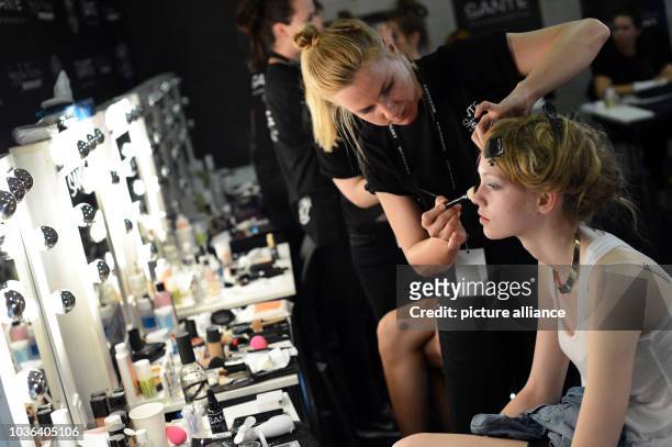 Model get prepared backstage prior to the beginning of the StyleNite show of designer Michael Michalsky during the Mercedes-Benz Fashion Week in...