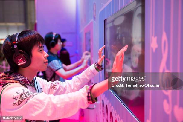 Attendees play a video game in the KLab Inc. Booth during the Tokyo Game Show 2018 on September 20, 2018 in Chiba, Japan. The Tokyo Game Show is held...