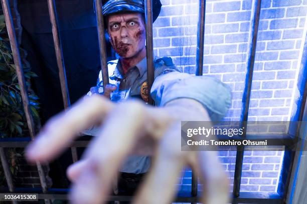 An actor dressed as a zombie from Capcom Co.'s Biohazard RE: 2 video game, known as Resident Evil 2 outside Japan, poses during the Tokyo Game Show...