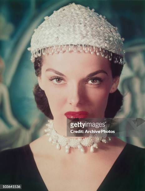 Headshot of actress Jane Russell pictured wearing a pearl-studded skull cap, with a fringe of pearls, USA, circa 1955. Russell is also wearing a...