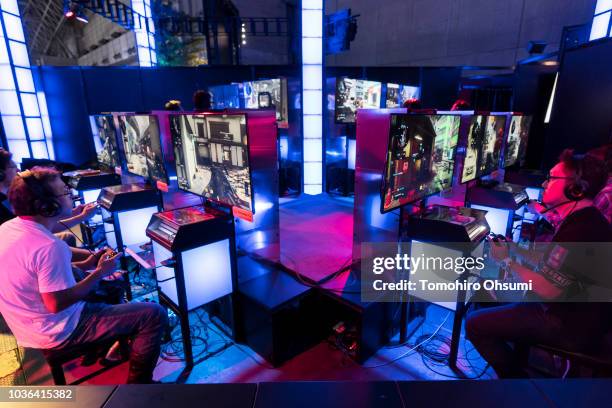 Attendees play video games on the PlayStation 4 video game console in the Sony Interactive Entertainment booth during the Tokyo Game Show 2018 on...