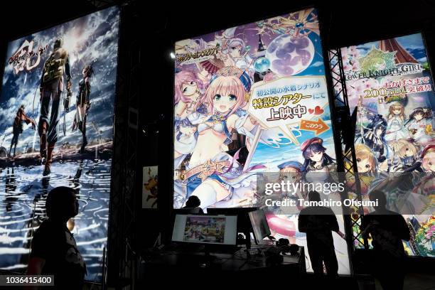 Attendees stand in front of the DMM Games booth during the Tokyo Game Show 2018 on September 20, 2018 in Chiba, Japan. The Tokyo Game Show is held...