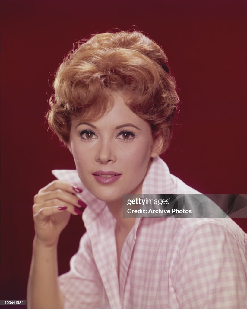 Actress Jill St. John pictured with her right hand holding the collar