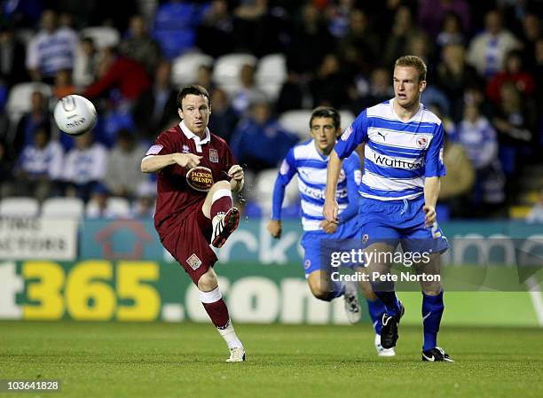 Kevin Thornton of Northampton Town plays the ball watched by Alex Pearce of Reading during the Carling Cup Round Two match between Reading and...