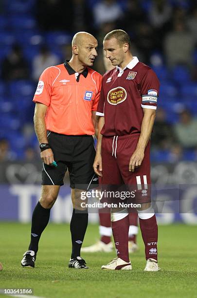 Referee Ray East talks to Andy Holt of Northampton Town during the Carling Cup Round Two match between Reading and Northampton Town at the Madjeski...