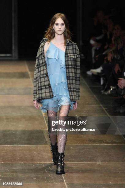 Model wears a creation by French designer Hedi Slimane as part of Saint Laurent fall/winter 2013/2014 collection presented during Paris pret-a-porter...