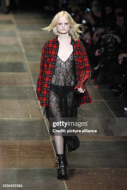 Model wears a creation by French designer Hedi Slimane as part of Saint Laurent fall/winter 2013/2014 collection presented during Paris pret-a-porter...