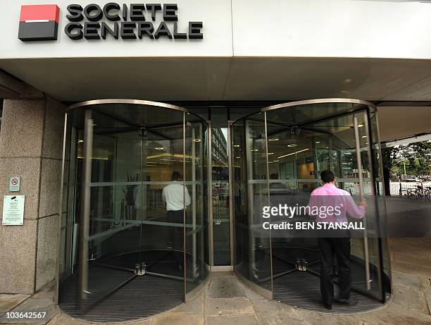 Man enters the offices of French bank Societe Generale in central London on August 26, 2010. Britain's financial regulator said it had fined French...