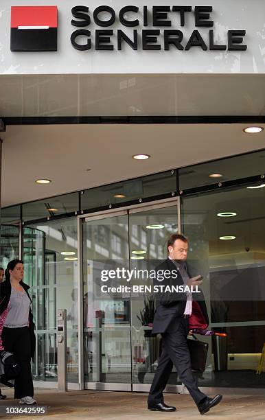 People walk past the entrance to French bank Societe Generale in central London on August 26, 2010. Britain's financial regulator said it had fined...