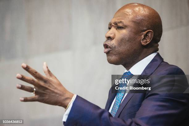 Lesetja Kganyago, governor of South Africa's central bank, gestures as he speaks during a news conference to announce interest rates in Pretoria,...