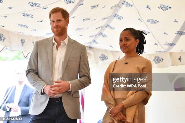 Prince Harry, Duke of Sussex and Doria Ragland listen to Meghan, Duchess of Sussex speaking at an event to mark the launch of a cookbook with recipes...
