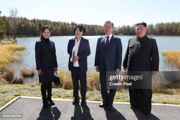 North Korea's leader Kim Jong Un and his wife Ri Sol Ju pose with South Korean President Moon Jae-in and his wife Kim Jung-sook during a visit to...