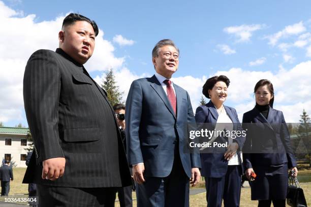 North Korea's leader Kim Jong Un and his wife Ri Sol Ju pose with South Korean President Moon Jae-in and his wife Kim Jung-sook during a visit to...