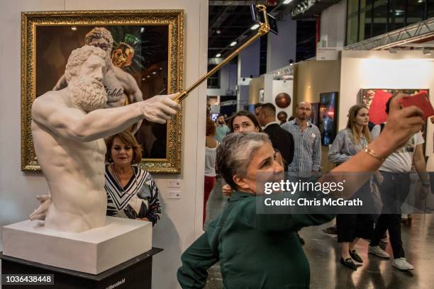 Woman poses for a selfie with Hercules Selfie an artwork by Emre Yusufi on display at Contemporary Istanbul on September 20, 2018 in Istanbul,...