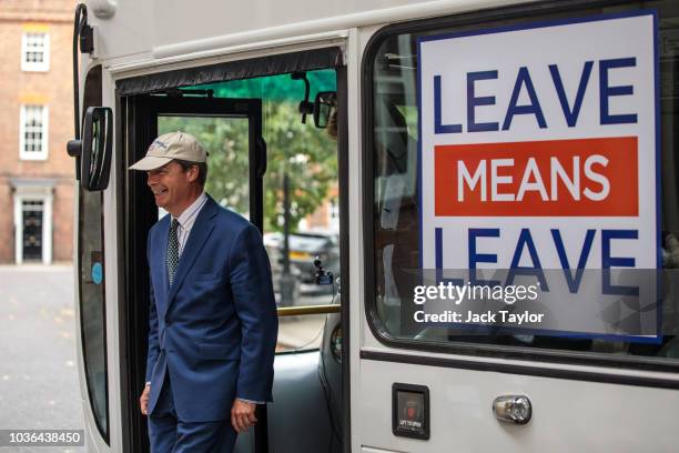 And former leader of the UK Independence Party Nigel Farage steps off pro-Brexit 'Leave Means Leave' campaign bus in Westminster on September 20,...