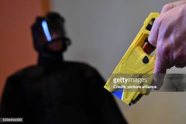 Police officer demonstrates the use of a taser at a press conference in Berlin, Germany, 09 February 2017. The non-lethal weapons are being tested...