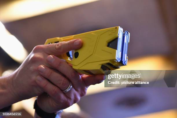 Police officer demonstrates the use of a taser at a press conference in Berlin, Germany, 09 February 2017. The non-lethal weapons are being tested...