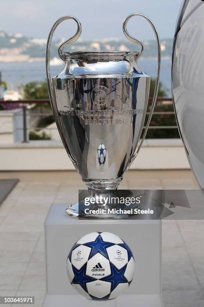 An Adidas ball on show alongside the Champions League trophy during the UEFA Champions League Group Stage draw at the Grimaldi Forum on August 26,...