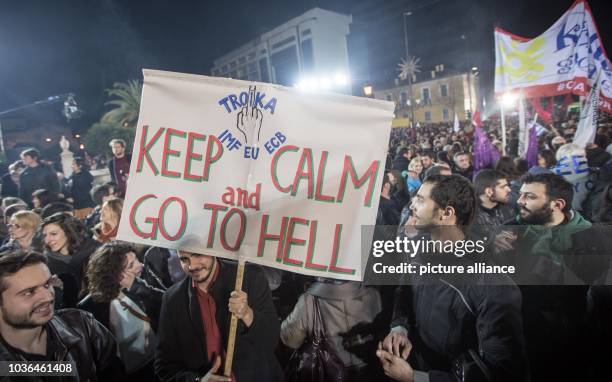 Poster with the Slogan "Troika- KEEP CALM AND GO TO HELL" is seen after Alexis Tsipras leader of the radical left main opposition party Syriza held...