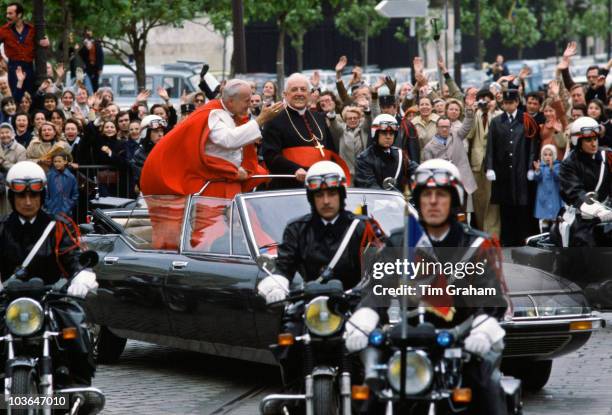 Open-topped car, police outriders and minimal security for Pope John Paul II waving to the crowd in Paris during his official visit to France