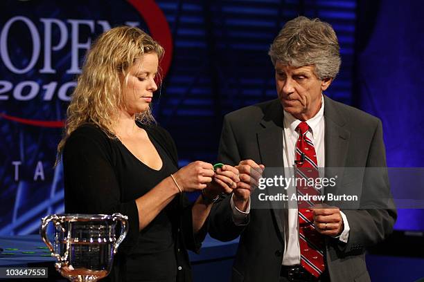 Kim Clijsters of Belgium and referee Brian Earley participate in the Draw Ceremony prior to the start of the 2010 U.S. Open at the USTA Billie Jean...