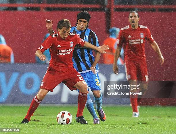 Lucas Leiva of Liverpool competes with Gustavo Colman of Trabzonspor during the Europa League play off, 2nd leg match between Trabzonspor and...