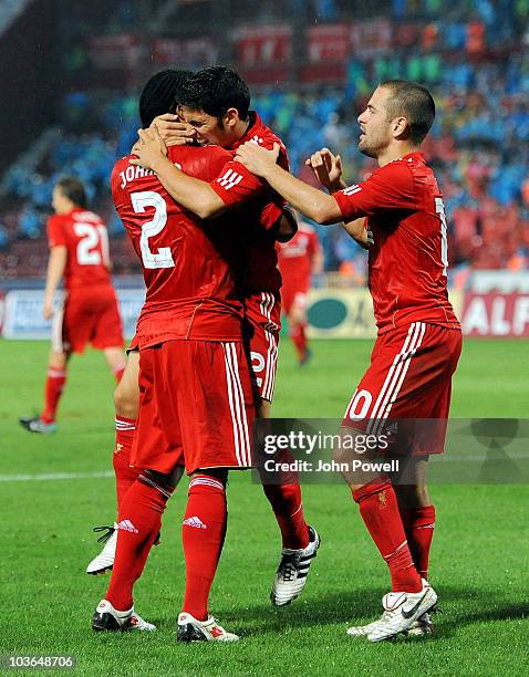 Glen Johnson of Liverpool celebrates with team mates Dani Pacheco and Joe Cole after Remzi Griay Karcar of Trabzonspor scored an own goal during the...