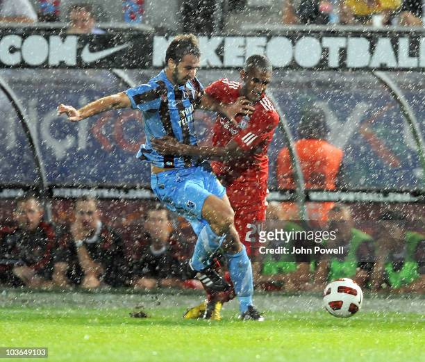 David Ngog of Liverpool competes with Remzi Giray Kacar of Trabzonspor during the Europa League play off, 2nd leg match between Trabzonspor and...