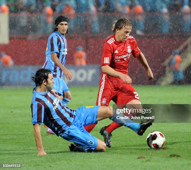 Lucas Leiva of Liverpool competes with Selcuk Inan of Trabzonspor during the Europa League play off, 2nd leg match between Trabzonspor and Liverpool...