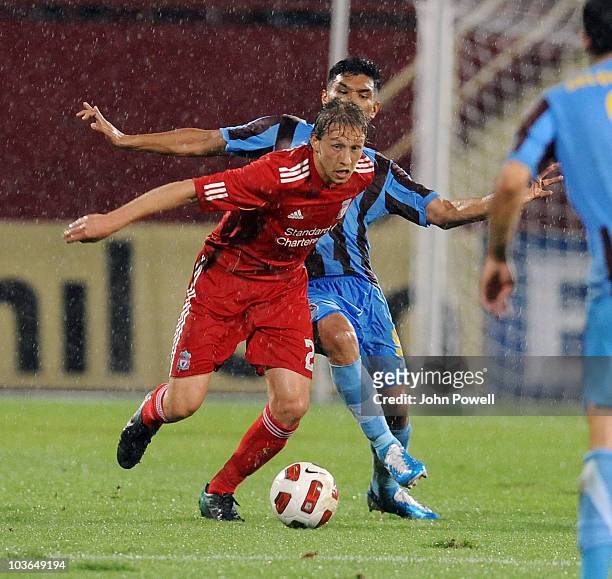 Lucas Leiva of Liverpool competes with Teofilo Gutierrez of Trabzonspor during the Europa League play off, 2nd leg match between Trabzonspor and...