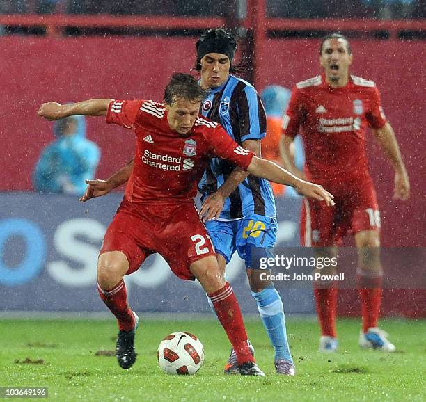 Lucas Leiva of Liverpool competes with Gustavo Colman of Trabzonspor during the Europa League play off, 2nd leg match between Trabzonspor and...