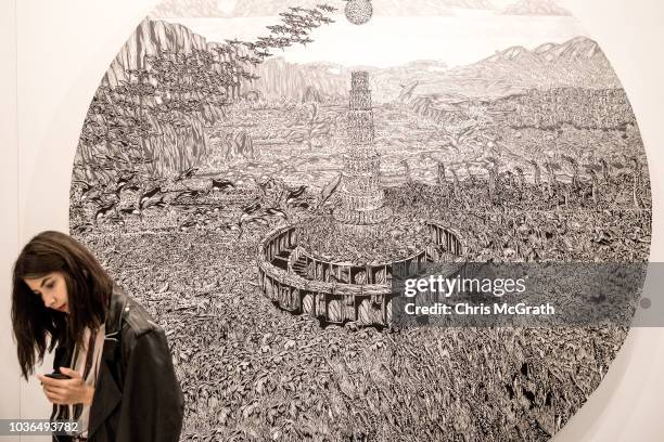 Woman walks in front of artwork on display at Contemporary Istanbul on September 20, 2018 in Istanbul, Turkey. The 13th edition of Contemporary...