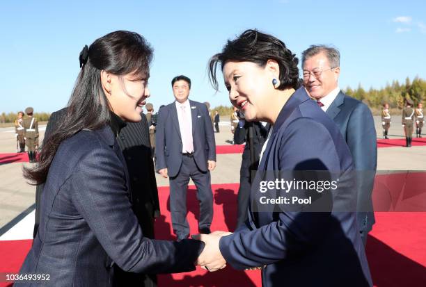 Ri Sol Ju , wife of North Korea's leader Kim Jong Un, bids farewell to Kim Jung-sook , wife of South Korean President Moon Jae-in, on Moon's...