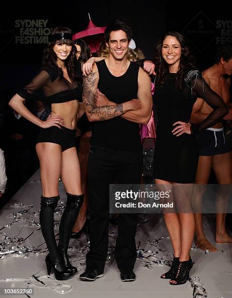 Mitchell Johnson and Giaan Rooney pose alongside models on the catwalk during the Hot In The City Intimates group show as part of Rosemount Sydney...
