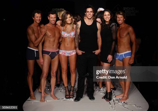 Erin McNaught, Mitchell Johnson and Giaan Rooney pose alongside models on the catwalk during the Hot In The City Intimates group show as part of...