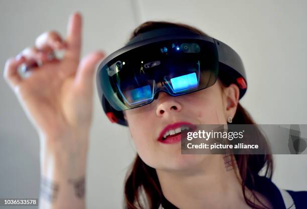 Young woman looks through a Microsoft hololens at the labore:tory at the internet conference re:publica in Berlin, Germany, 8 May 2017. The...