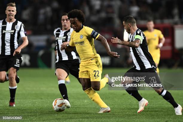 Chelsea's Brazilian midfielder Willian vies for the ball with PAOK's Greek midfielder Dimitrios Pelkas and PAOK's Portuguese midfielder Vieirinha...