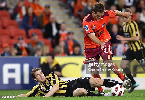 Luke Devere of the Roar and Chris Greenacre of the Phoenix compete for the ball during the round four A-League match between the Brisbane Roar and...