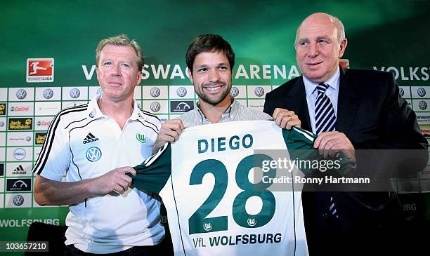 Ribas Da Cunha Diego poses with manager Dieter Hoeness and head coach Steve McClaren of VfL Wolfsburg during a press conference at Volkswagen Arena...