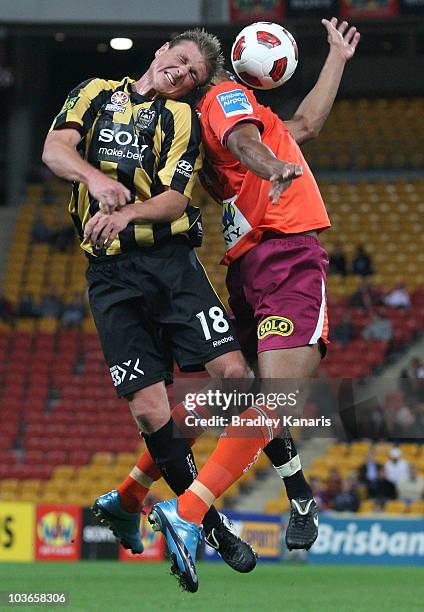 Reinaldo of the Roar and Ben Sigmund of the Phoenix compete for the ball during the round four A-League match between the Brisbane Roar and the...