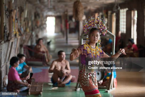 An Iban woman is performing a dance inside a traditional Iban longhouse near Lubok Antu, Malaysia, on 23 October 2014. Photo: Sebastian Kahnert -...