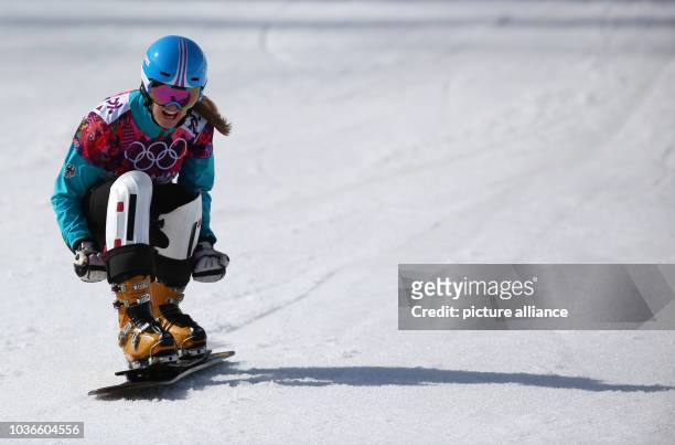 Anke Karstens of Germany celebrates after her run during the Ladies' Snowboard Parallel Slalom Quarterfinals of the Snowboard event in Rosa Khutor...