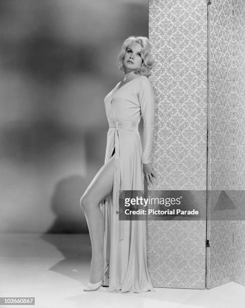 Full-length shot of actress Carroll Baker pictured in a publicity portrait which was issued for the film, 'The Carpetbaggers', USA, circa 1964. Baker...